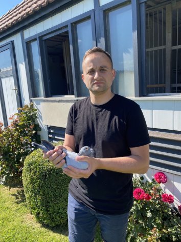 Thierry Bazire holding his winning pigeon